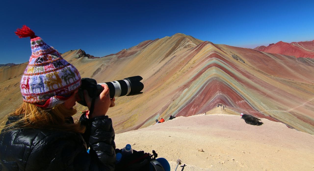 A photographer at the viewpoint for Vinicunca, aka Rainbow Mountain, Peru
